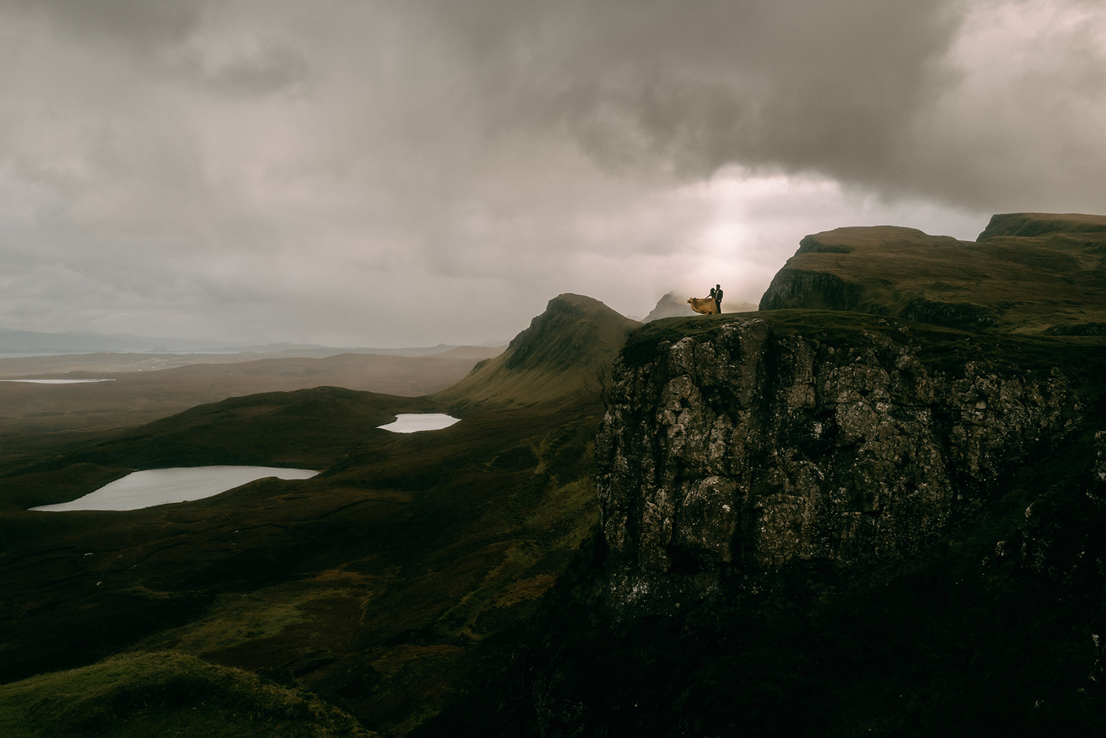 photo of couple on the Quiraing with light beam coming through the clouds