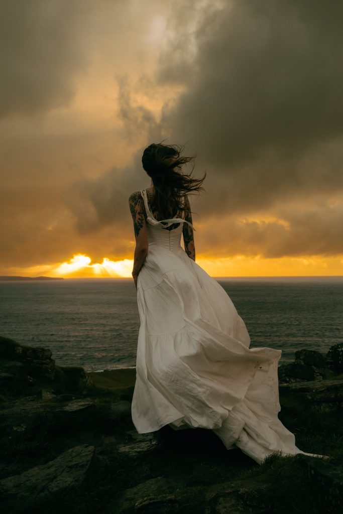 bride on the cliff of Duntulm on the Isle of Skye - Isle of Skye Elopement Guide by Belle Art Photography